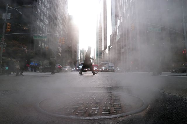 Steam rises from a sewer as a man crosses Sixth Avenue on February 1, 2019 in New York City.